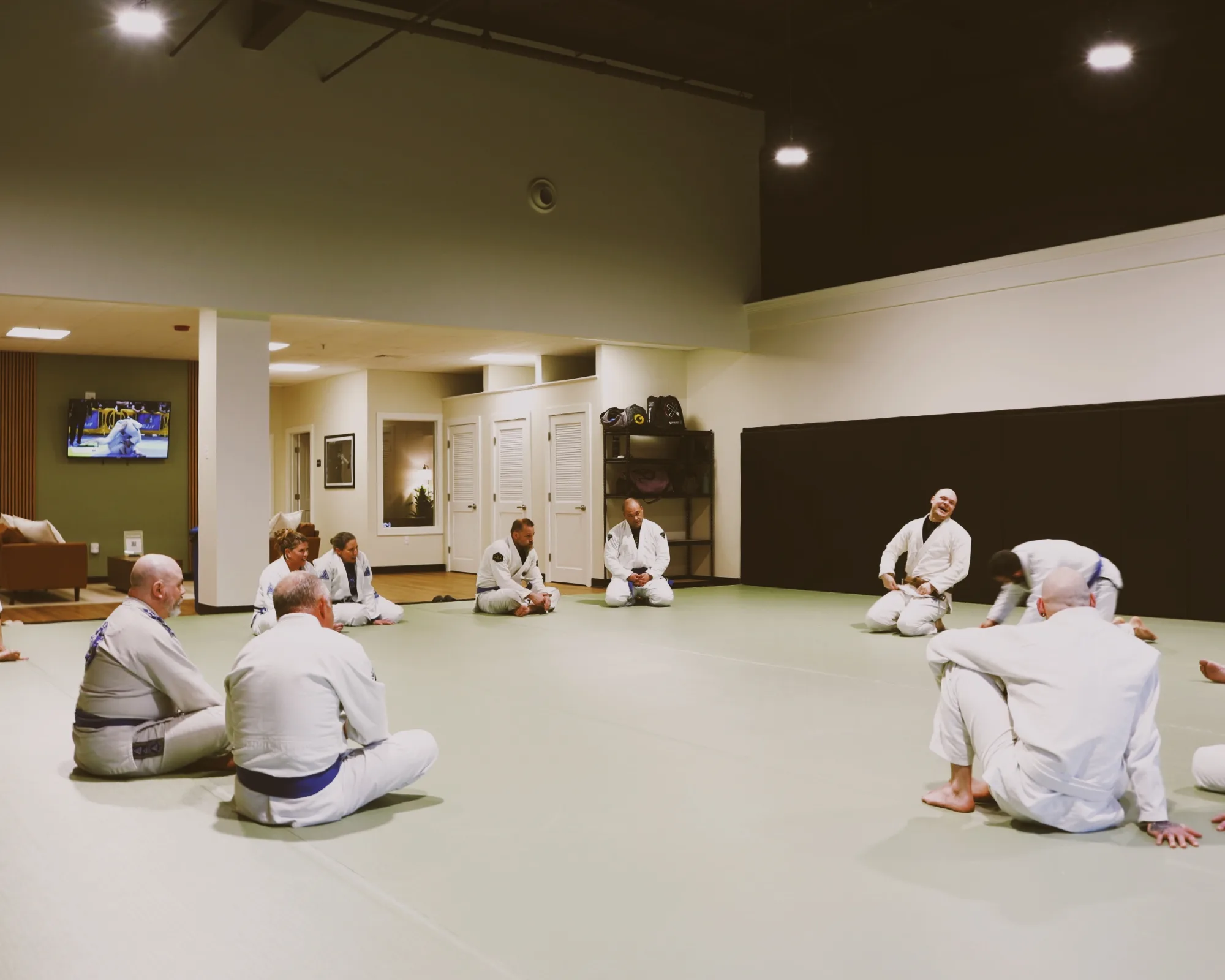 An instructor addressing a seated class in the academy's main training room.