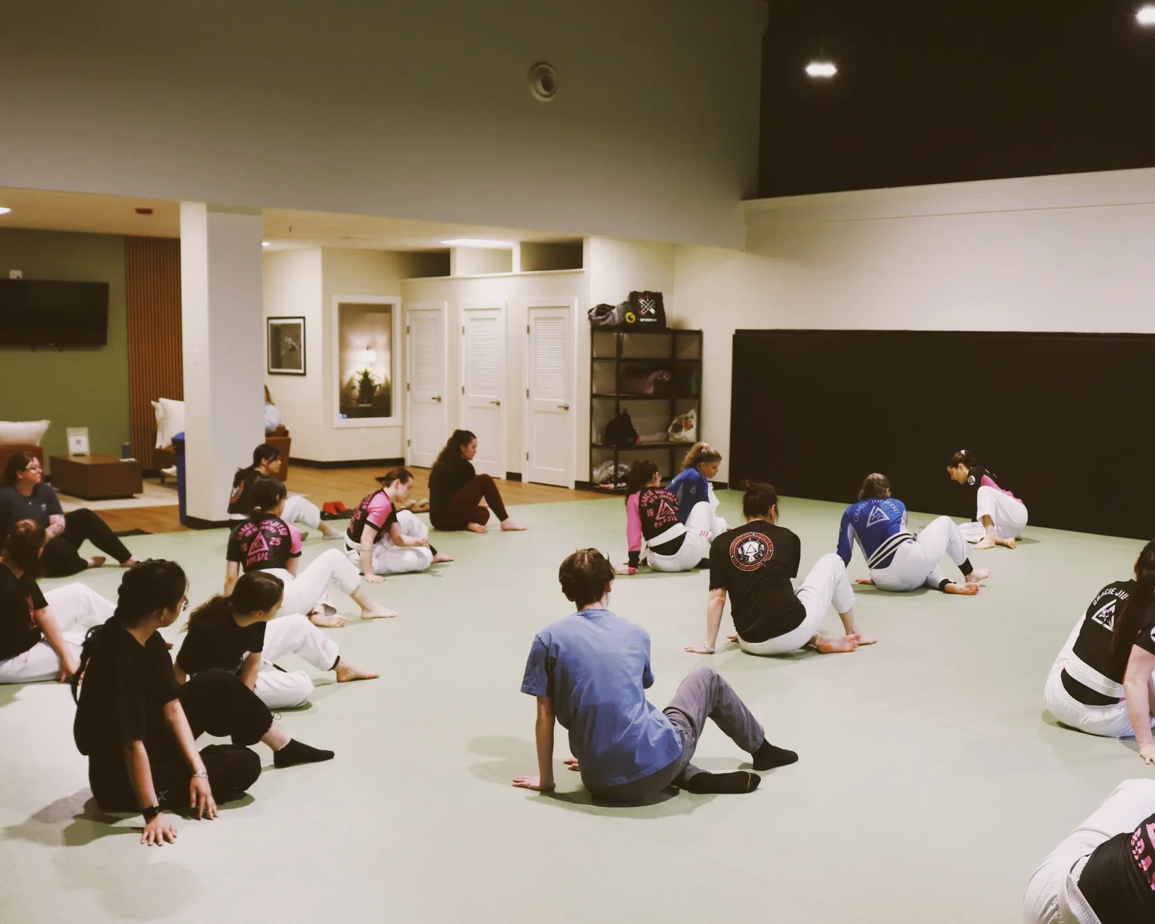 A mixed group of students stretching together before class.