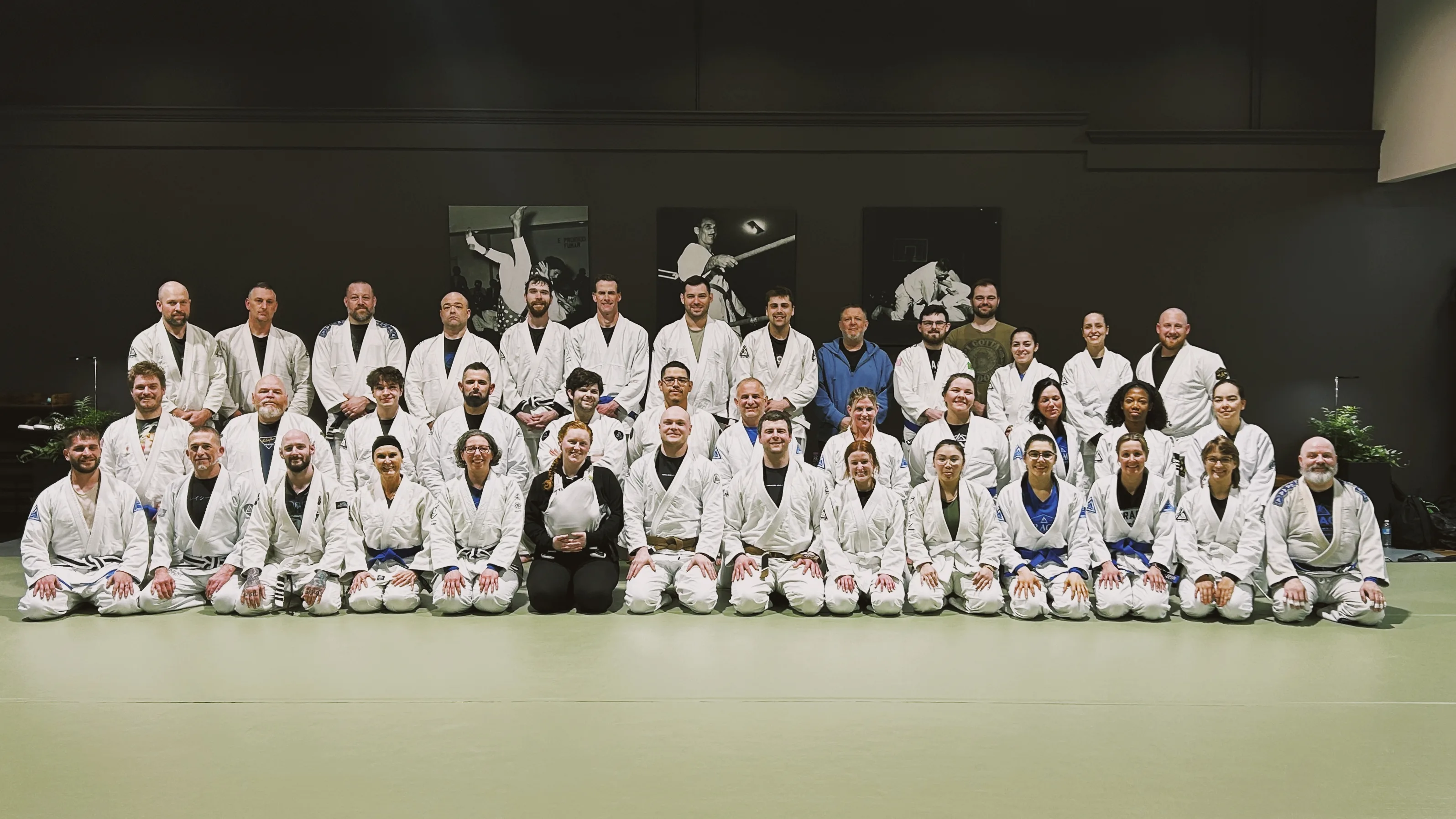 The full academy roster gathered together on the mat after class.