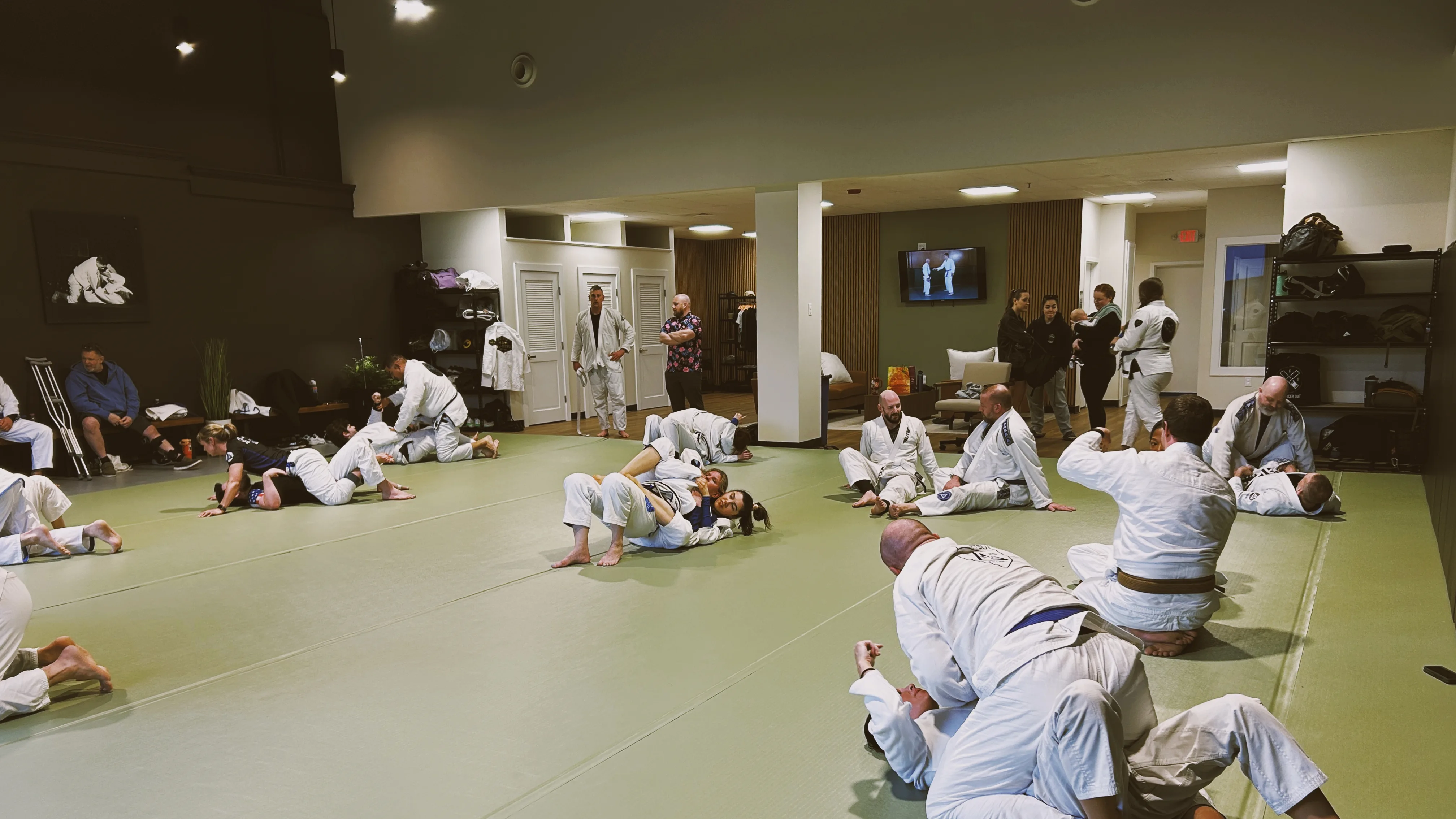 Students practicing positions during open training on the mat.